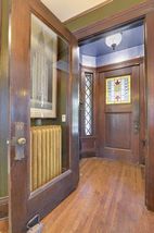 You are welcomed into the home through the Rich Entry Vestibule with Stained Glass Window...