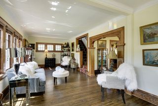 The Living Room & Sunroom feature Hardwood Floors & Natural Woodwork...