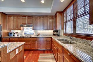Large double hung Marvin windows over the sink area. Lots of upper cabinets and drawers.