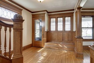 The Large Entry Hall features STUNNING Woodwork, Columns, Leaded Glass & Window  Bench...
