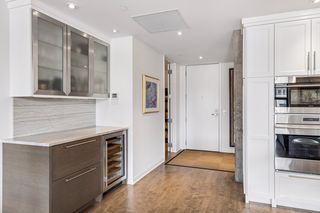 Bar counter with wine refrigerator and two refrigerated drawers plus display cabinets.