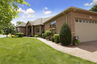 Paver driveway and sidewalk.  Oversized garage with stairways to upper and lower garages