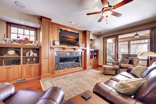 Cherry custom cabinets frame the gas fireplace and hi - def tv above.