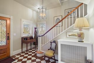 The front hall staircase takes you upstairs to the Sitting Room, Master Bedroom, Master Bath and Closet