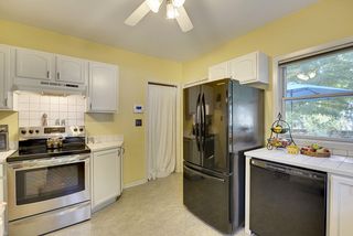 The Light-Filled Kitchen features tons of Cabinet Space & Stainless Steel Range.