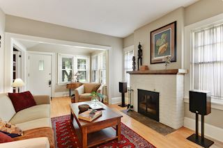Living room with wood burning fireplace and south facing windows
