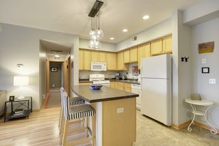 The Kitchen features a convenient Center Island & High-End Light Fixture...