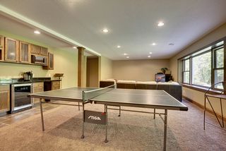 A wet bar area with a wine refrigerator, microwave and bar sink round out the entertainment area.