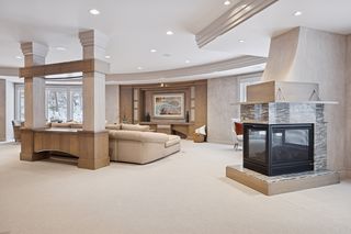 Three sided fireplace can be enjoyed from all the family areas.