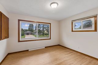 Main-level bedroom with refinished hardwood floors and abundant natural light