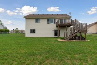 Large deck with stairs designed to leave space for a backyard patio