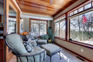 Warm, inviting Sun Porch flanked by large Marvin windows and sliding french doors.
