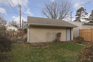 Newer 2000 built 2 car garage with raised beds to the left.  New fence