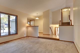Large living room windows. Central staircase allows for easy access to family room below or bedrooms above. 