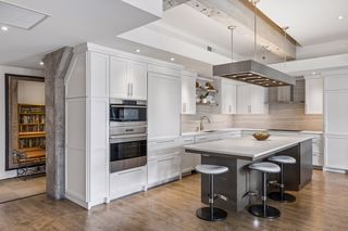 A full kitchen remodel added luxury appliances, double ovens with a steam oven, 5-burner gas cooktop, wine refrigerator, refrigerated drawers, and a drawer microwave.