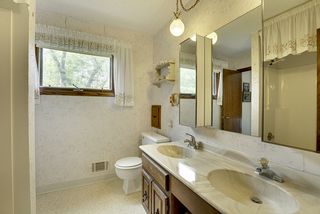 Upper level bathroom - double vanity with shower/tub and higher-set window for light and privacy.