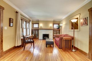 The Living Room Fireplace is surrounded by Original Built-In Bookcases...