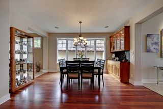 Open dining area, brazilian cherry floors, custom dining hutch with granite top and backsplash