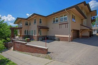 Pleasant Ave view of the building with alley access to the back entryway and garages.