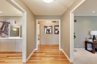 ...to the right, the carpeted formal living room and sunroom, to the left the formal dining room and kitchen and family room and straight ahead to the 3 main floor bedrooms.