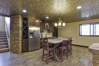 Custom designed wet bar with full sized fridge, sink, microwave.