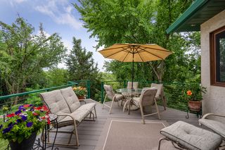 Off the kitchen is the tree-top maintenance free deck with stairs to the backyard.