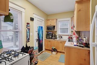 View of Kitchen in Apt #1.
Features updated kitchen with Custom Hickory Cabinets, Newer appliances, Hardwood floors and Thermal Pane Windows throughout.