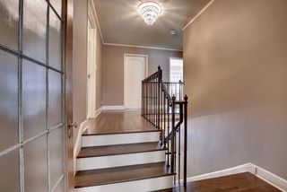 The Grand Staincase features original Iron Banisters and Hardwood Floors...