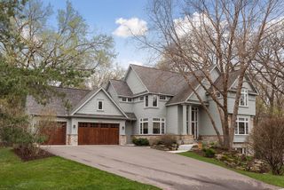 Beautiful mahagony garage doors enhance the cottage feel of the house