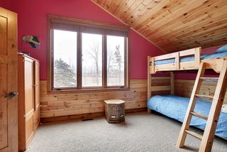 Beautiful, natural wood ceilings along with wood wainscoting give a warm bunk house feel.