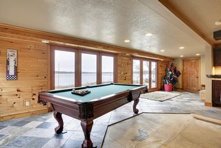 A large Recreation/Game room is flanked by patio doors and slate flooring. flooring