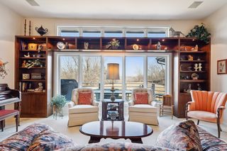 Second view of living room and the deck. The volume ceilings and the tall windows create a wonderful light filled area.