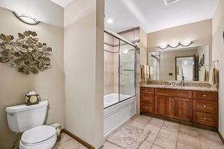 Lower Level Full Bathroom with Granite Top, Tile Floor and Jetted Bathtub and Ceramic Shower