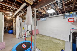 View of Laundry room in basement. Features newer front load washer and dryer. Glass block windows throughout.