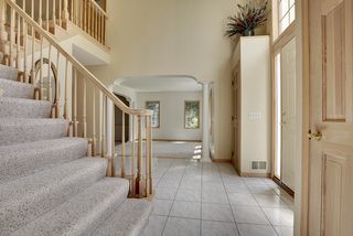 Foyer area looking south to the Formal Living space. Columns with an arched opening frame the opening.