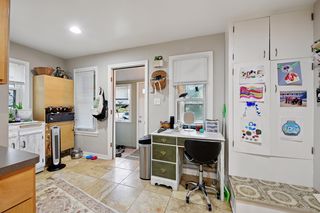 Another view of kitchen.
Updated kitchen features Stainless Steel appliances and Custom Maple cabinets, Travertine Tile flooring and a built-in pantry.
Also back door to foyer and basement.