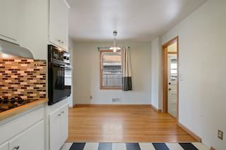 North side door leads to the wood deck with privacy fence and walk way to the detached garage.