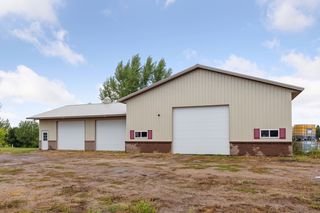Pole shed features 32 x 40 shop with bathroom, heat and air conditioning.  40 x 72 storage area