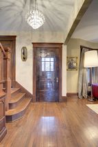 The spacious Entry Foyer is loaded with Natural Woodwork & the Original Entry Vestibule...