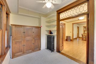 The Main Floor Sunroom features Book Shelves and Large, Vintage Storage Cabinet...