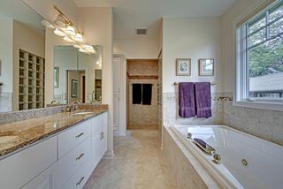 Ceramic floors, his and hers vanities, walk in shower with glass block privacy wall.