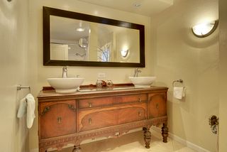 The 2nd Floor Full Bathroom features Tile Floors, High-End Lighting and this Antique Vanity with Vessel Sinks...
