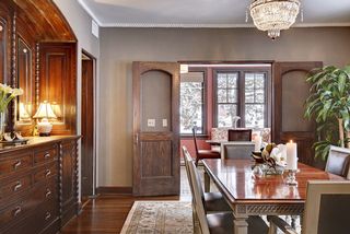 The Formal Dining Room features a Hand Carved (Original) Built-In Buffet...