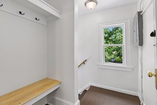 Upper unit rear entrance with landing and bench with coat hooks