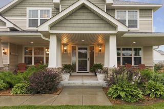 The porch provides a grand entrance to welcome friends, family, and neighbors. 