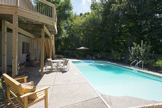Pool area is surrounded by an aggregate patio and iron fencing!