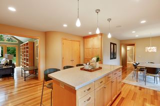 ...leading into the family room with fireplace and wall of windows and doors to the patio and backyard.