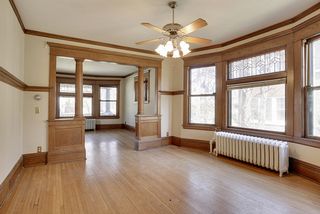 The Large Formal Dining Room features Leaded Glass Windows, Hardwood Floors, Original Columns & Built-In Buffet...