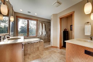 A Master Bath with separate vanities, solid surface tops, brushed nickel faucets, ceramic, radiant heated, electric floors.