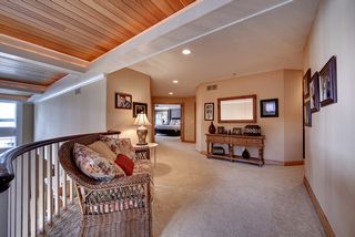 Sitting area near the top of stairs overlooking great room and foyer to the bedroom spaces.